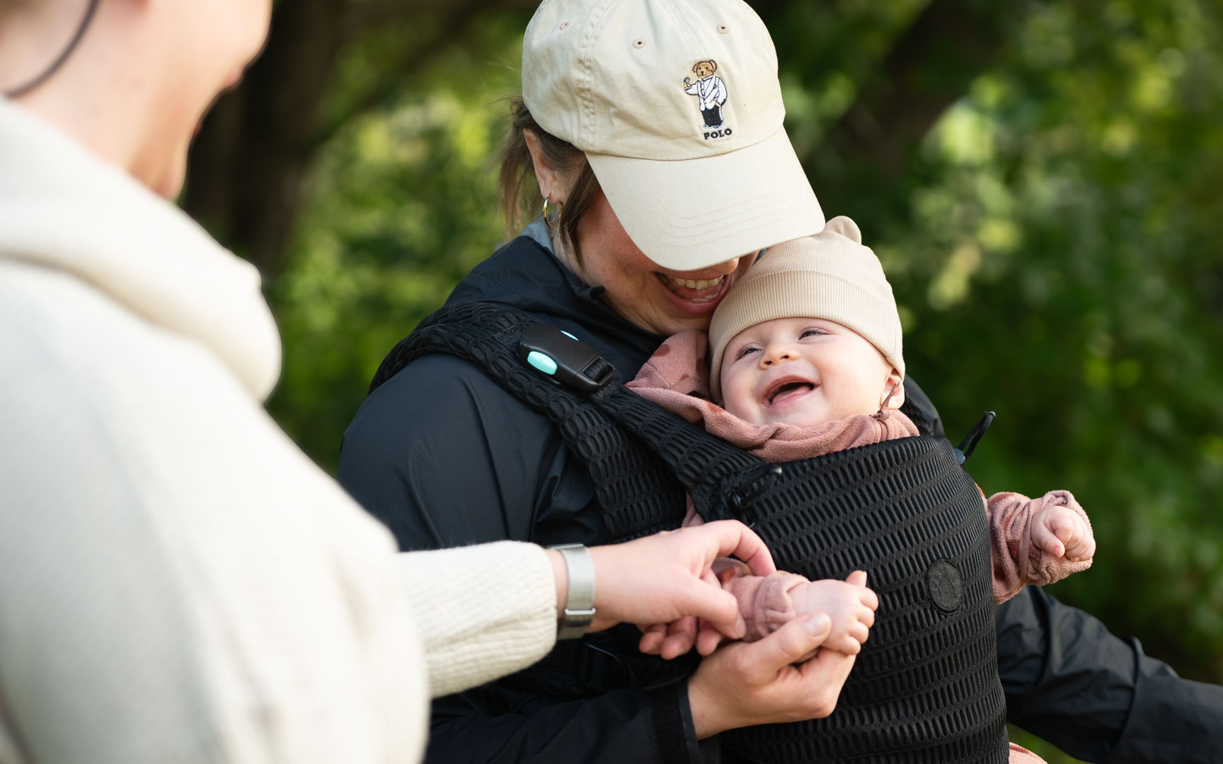 A woman holds a child in her arms.