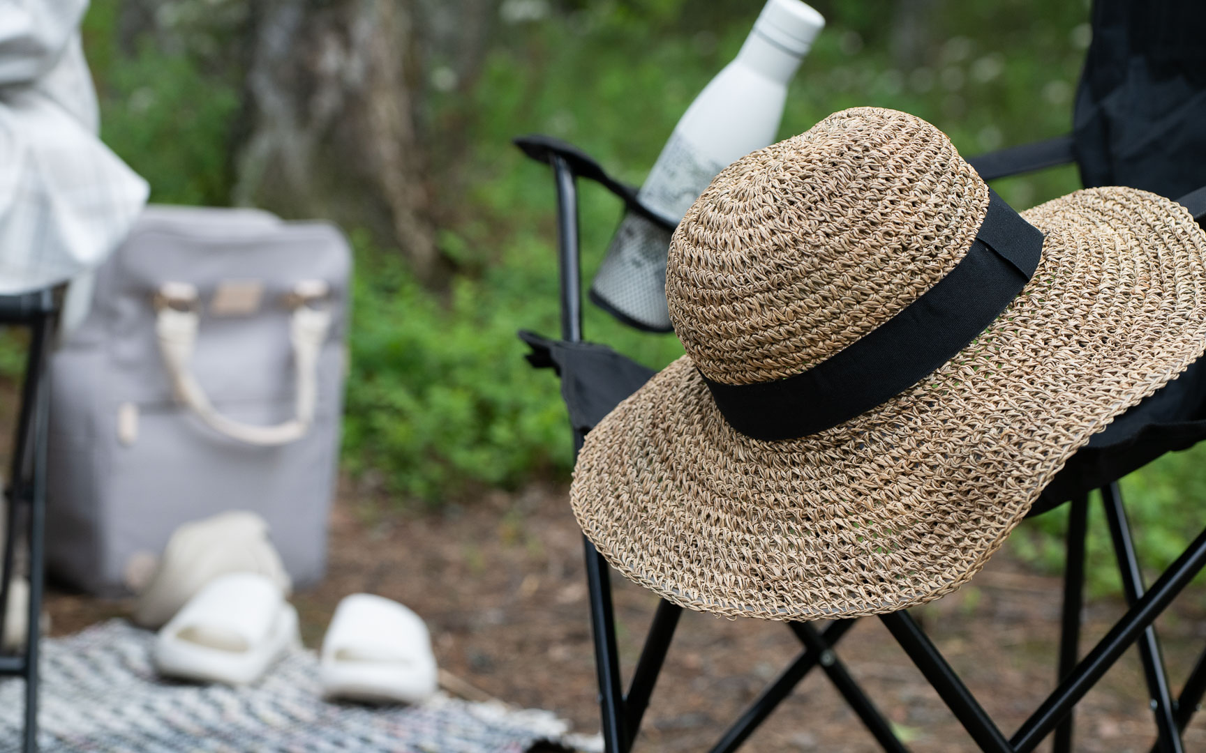 A summer hat on a camping chair.