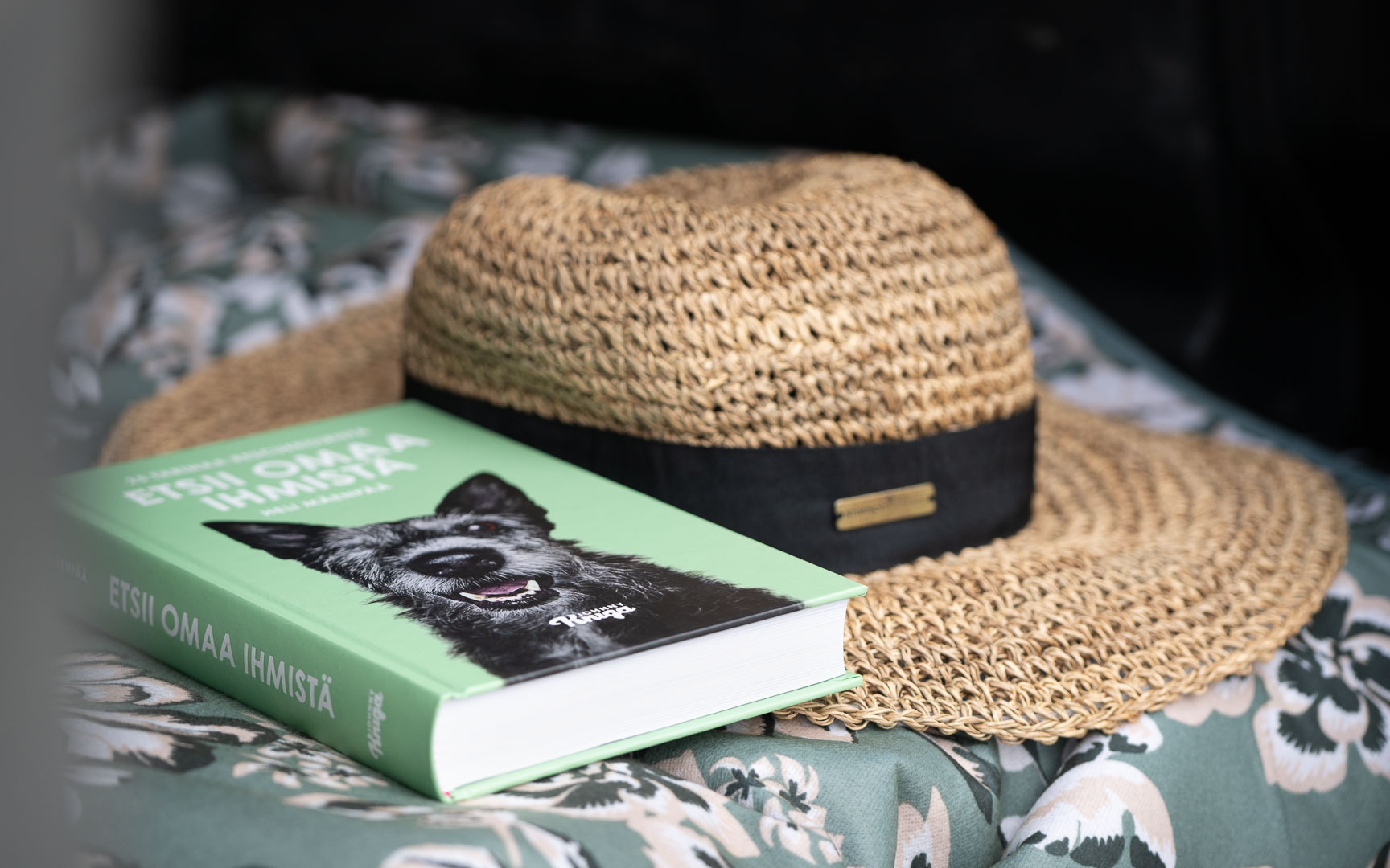 A summer hat and a book in a motorhome. 