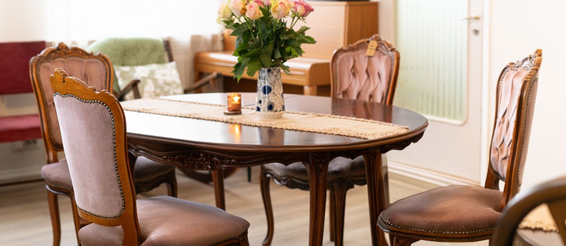 A table with a candle and a flower pot.