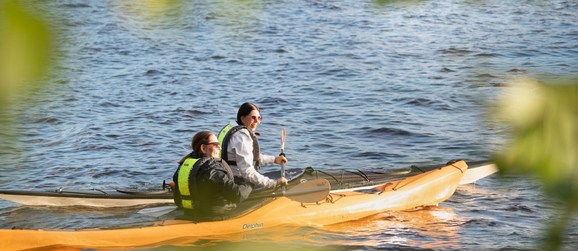 Two people kayaking on a lake.